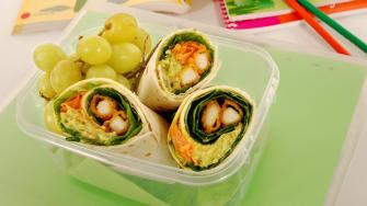 School lunch of fried chicken & avocado wrap sandwich